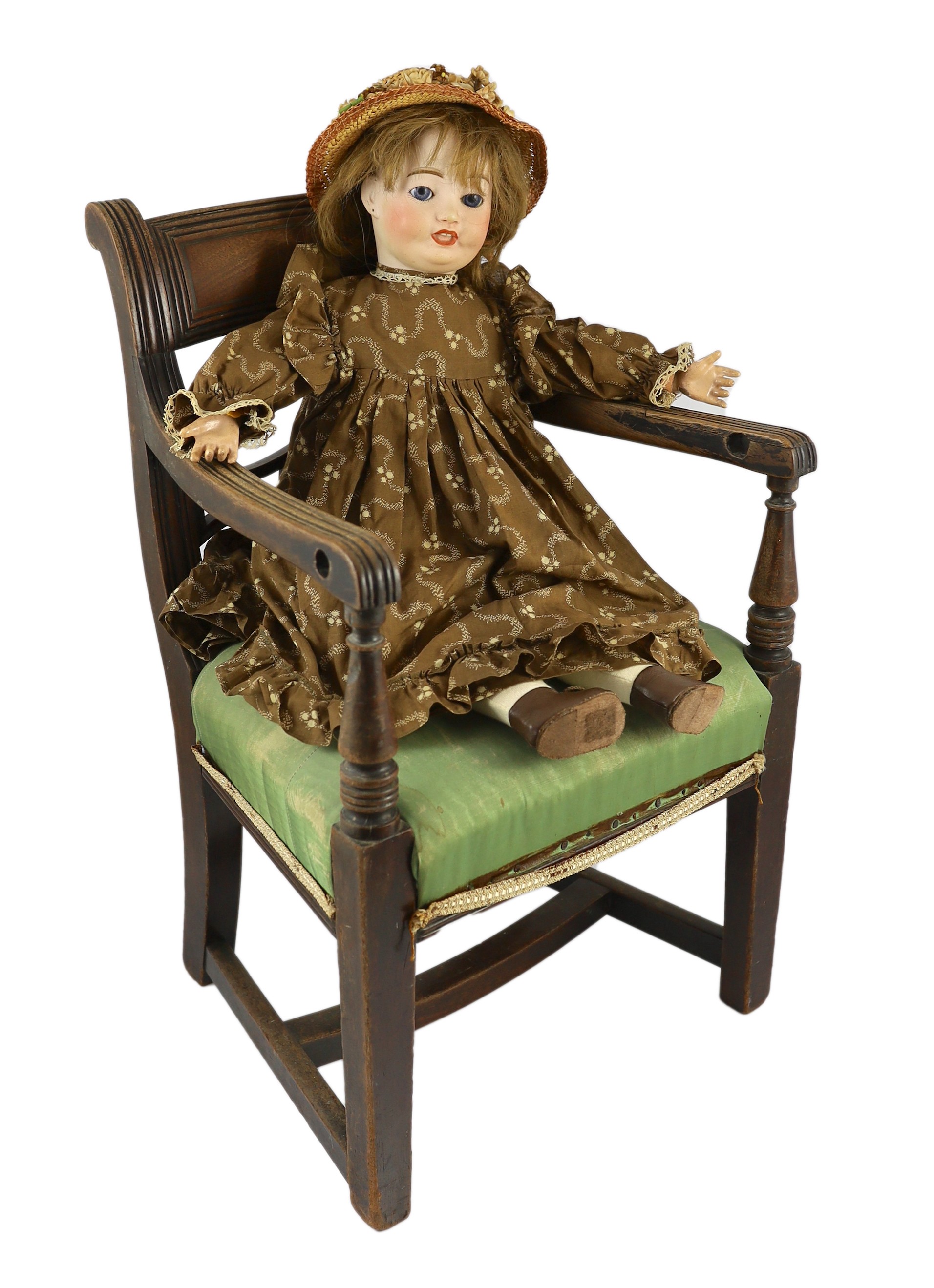 An Ed Tasson bisque doll, French, circa 1928, 21in. Please note the chair is for display purposes only.